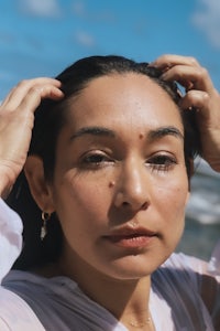 a woman posing with her hair on the beach